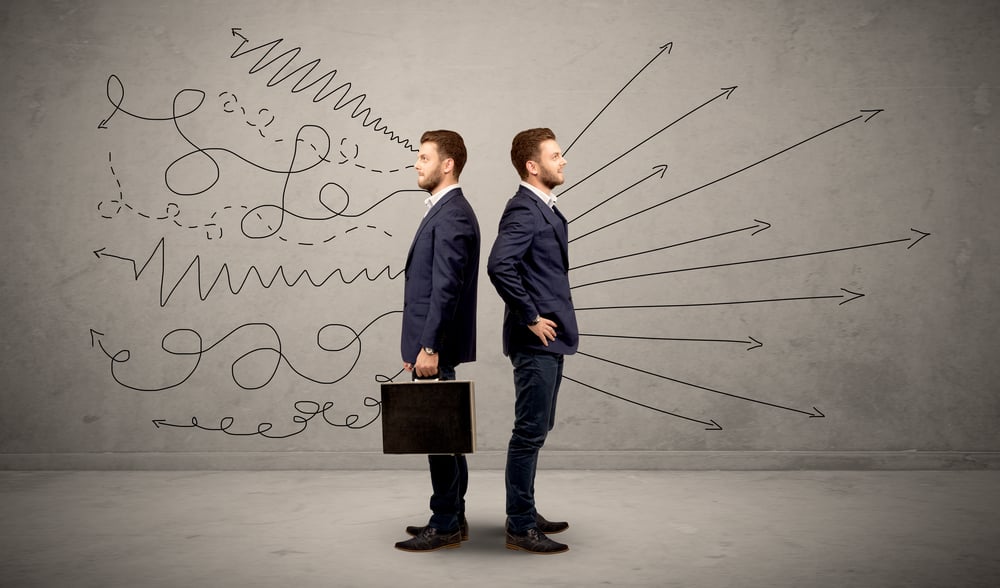 Young conflicted businessman choosing between two directions with arrows and scribbles around him