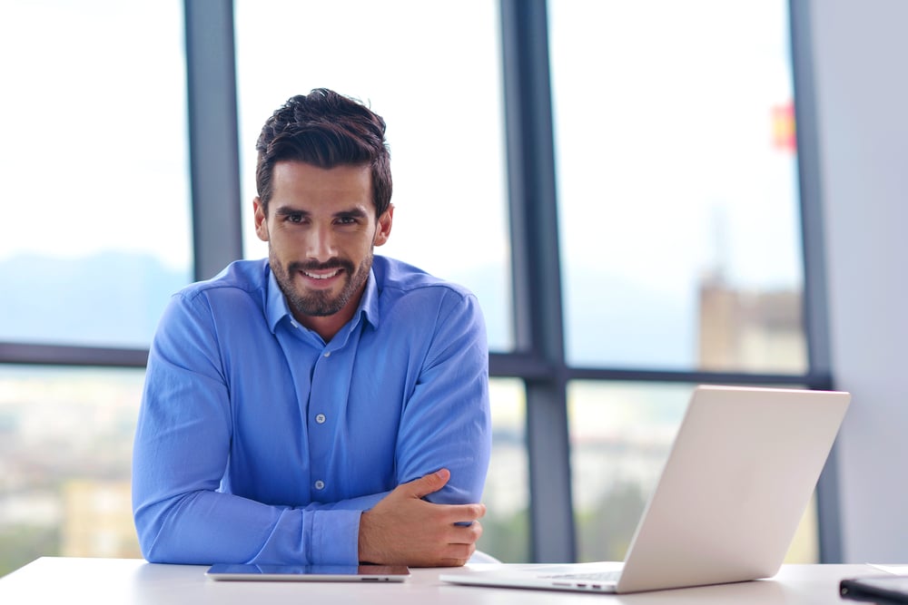 happy young business man work in modern office on computer